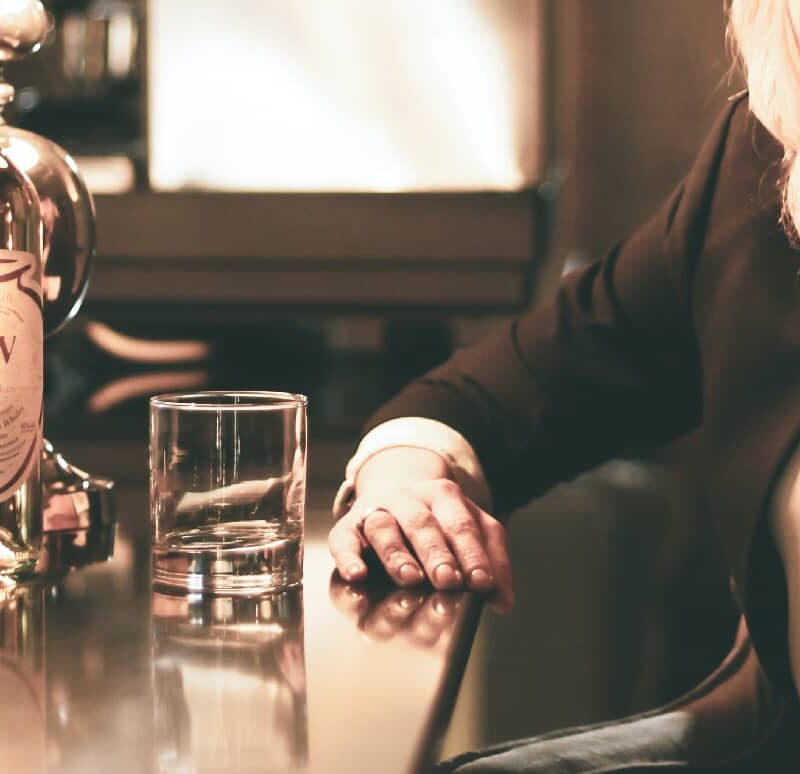 An array of alcohol bottles displayed on a table, showcasing a lifestyle that's ready to shift towards healthier evening routines.