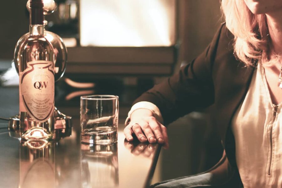 An array of alcohol bottles displayed on a table, showcasing a lifestyle that's ready to shift towards healthier evening routines.