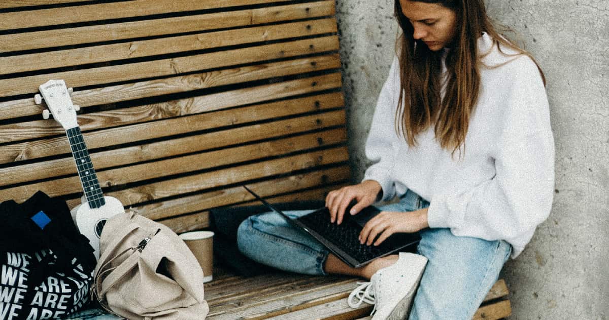 A focused woman typing on a laptop, illustrating the potential enhanced productivity and heightened focus associated with stimulant use.