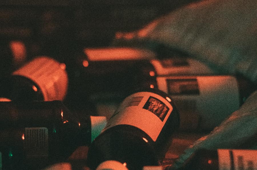 Cough syrup bottles displayed on a bed, highlighting the substance often involved when someone asks, 'what is robotripping?