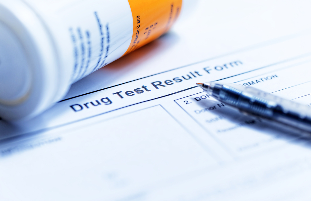 Drug Test Result Form Document with a pill container and pen