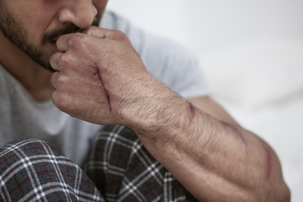 Adult male biting his nails, experiencing paranoia while undergoing cocaine withdrawal