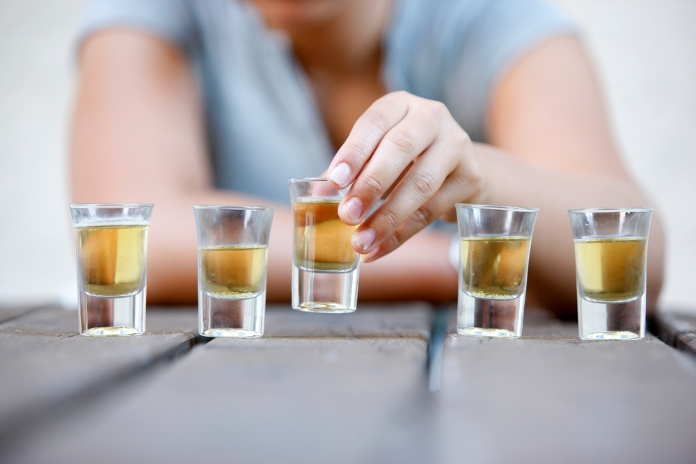 Man drinking several shots of tequila during the holiday season