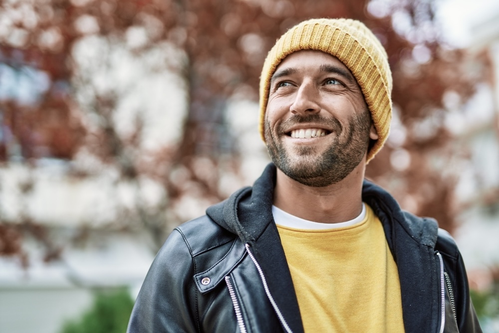 Male smiling towards the sun after completing addiction treatment and detox